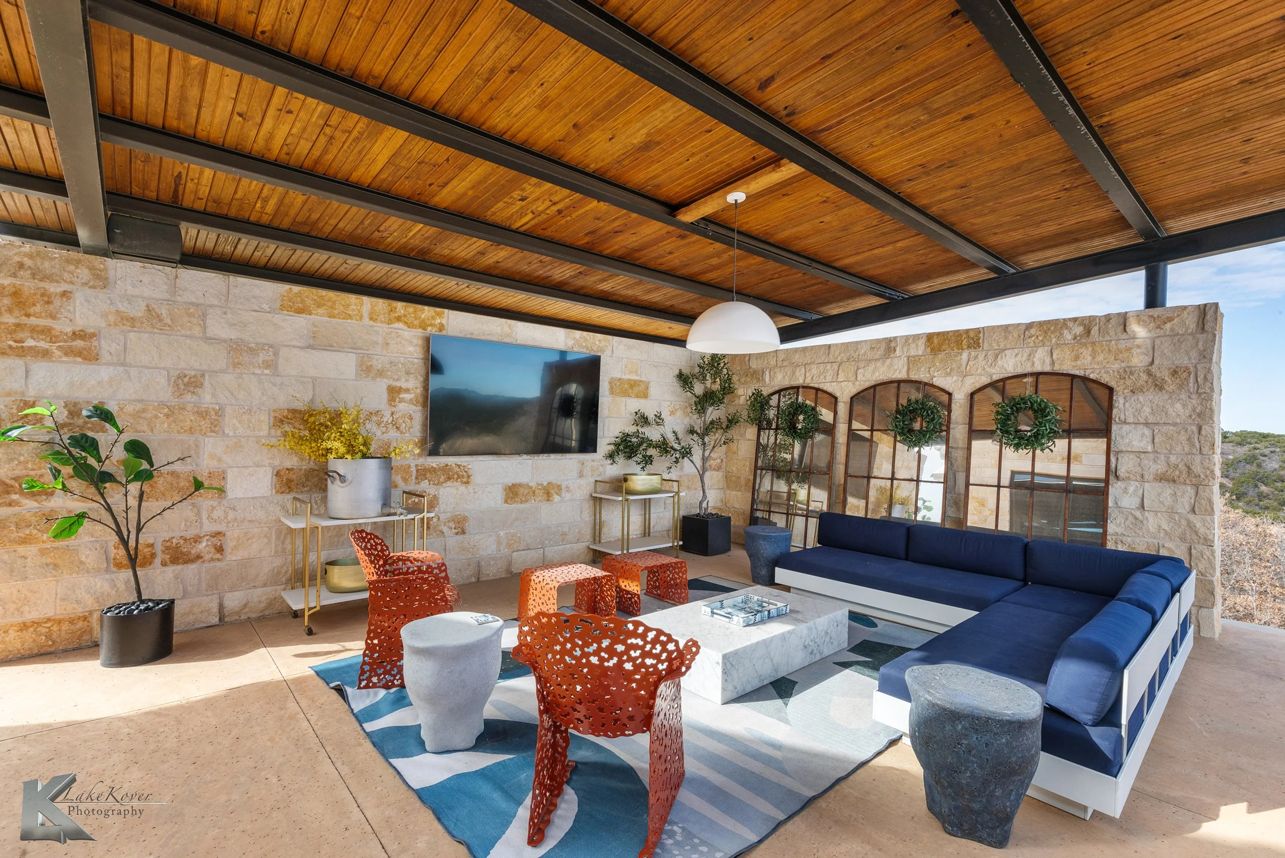 The outdoor cabana creates a comfortable living space with generous seating and views.
