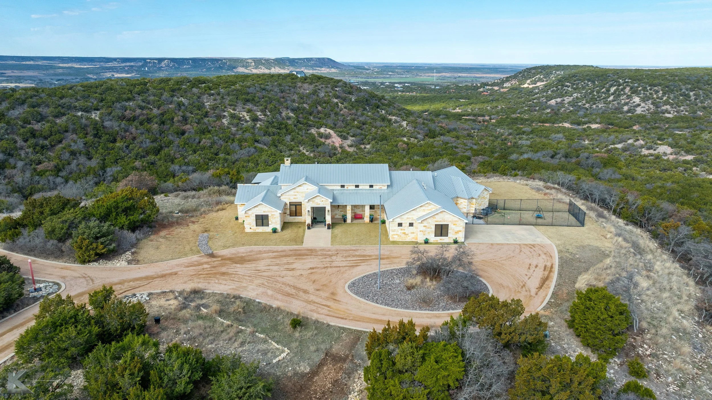 The standing seam metal roof adds modern durability and pair well with the limestone exterior.