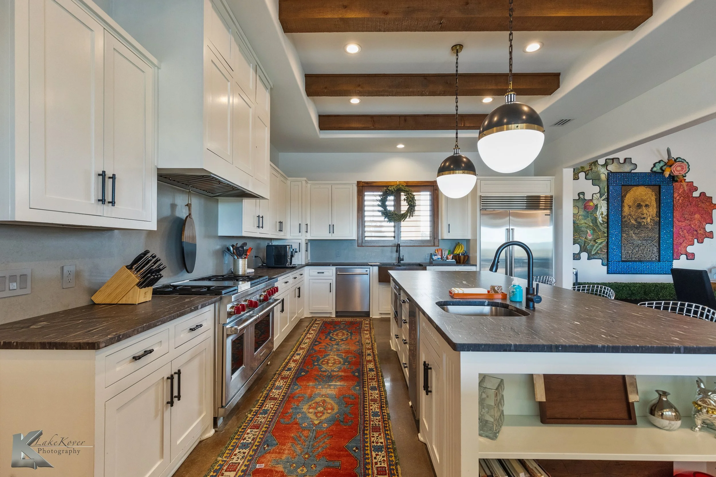 High-end stainless appliances, custom cabinetry, a farmhouse sink, & pendant lighting combine functionality with style.