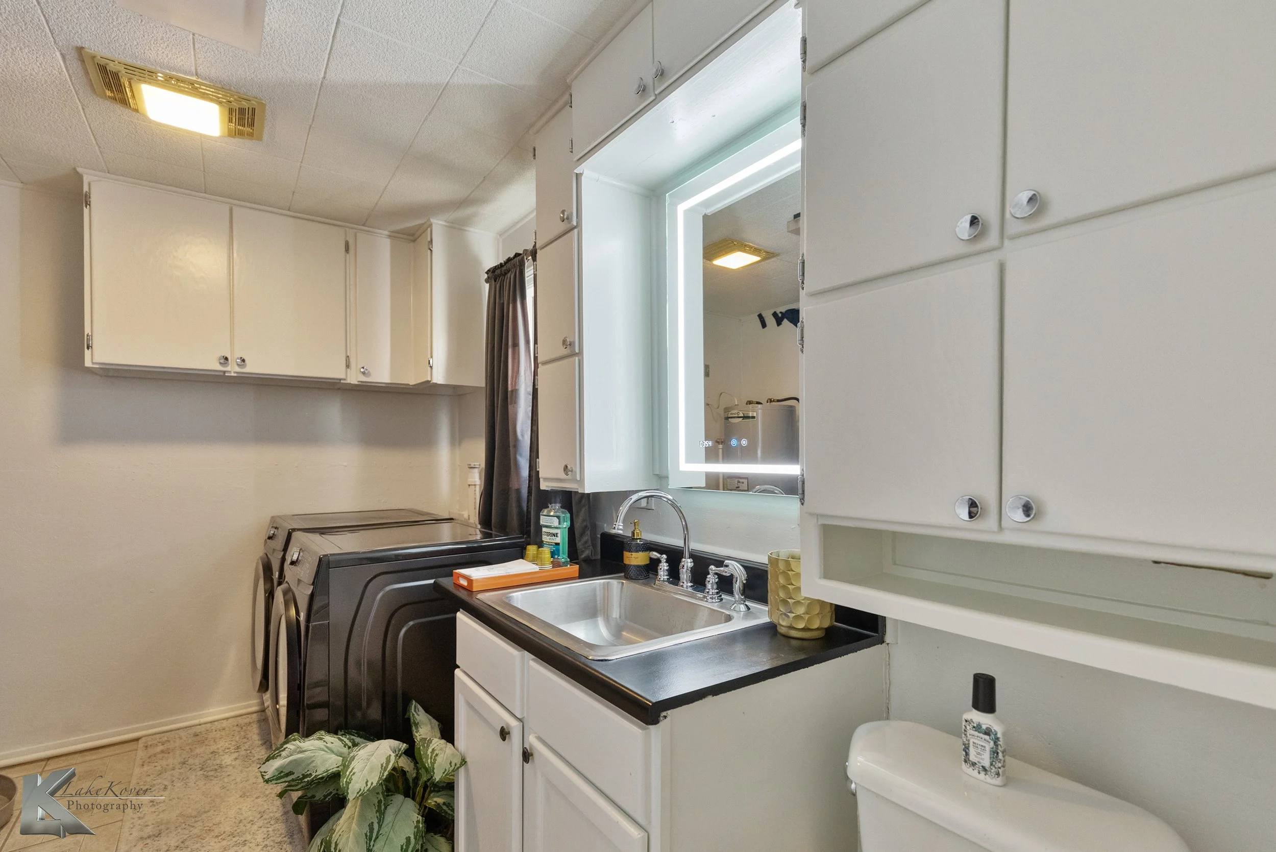 The secondary bathroom includes laundry units.