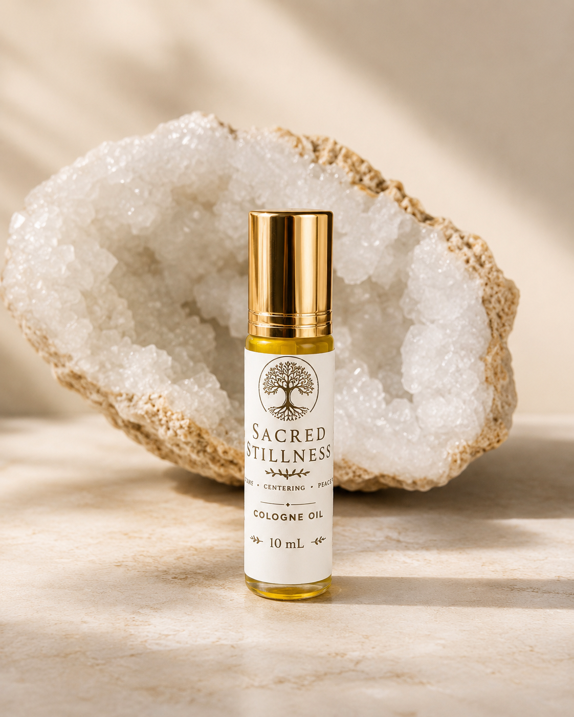 An image of sacred stillness with the tree of life on the label and a Crystal in the background