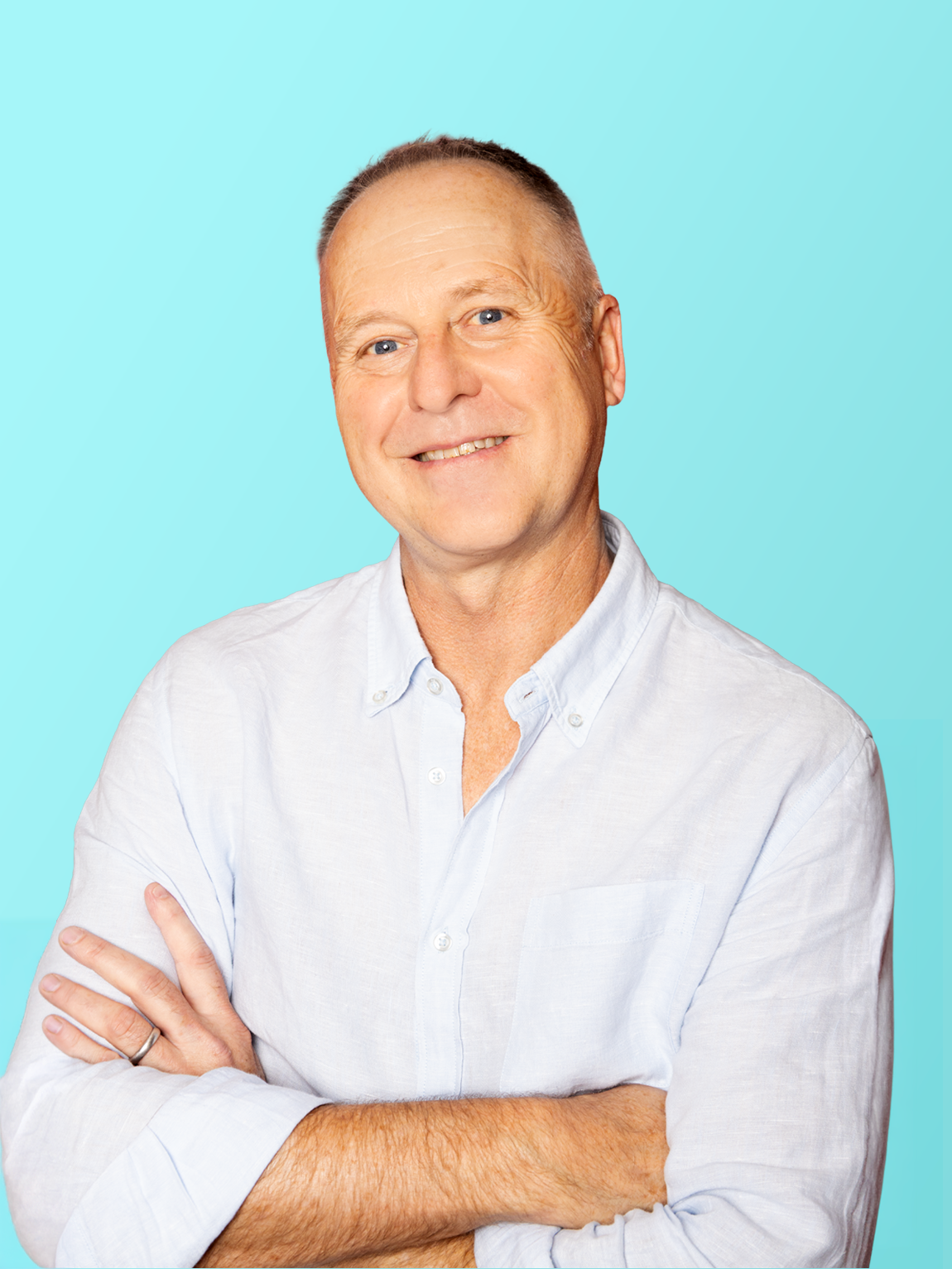 Portrait of a middle-aged man smiling, wearing a light button-up shirt, with arms crossed, against a light blue background.