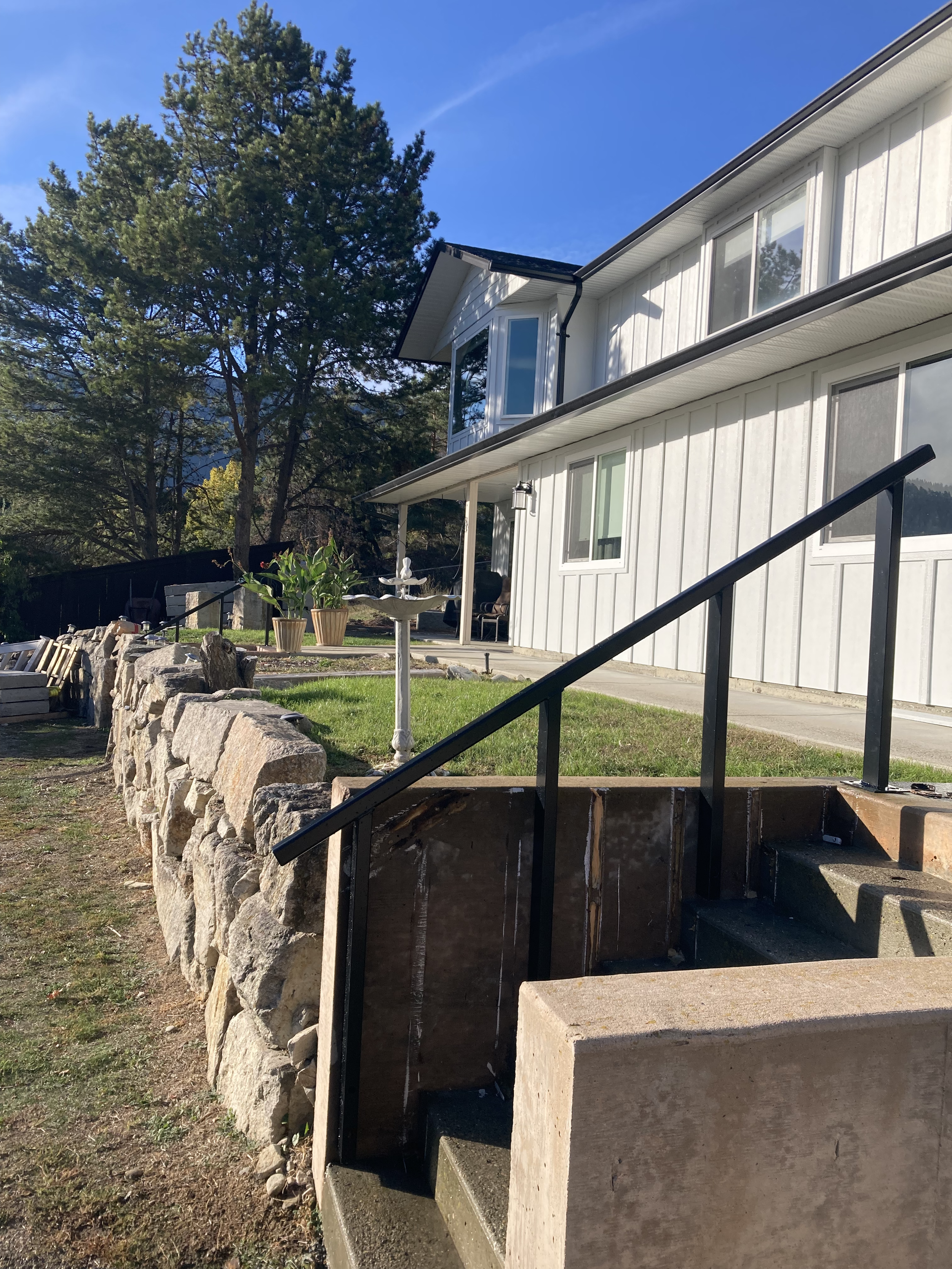 Photograph of stairs and a bannister leading to a duplex.