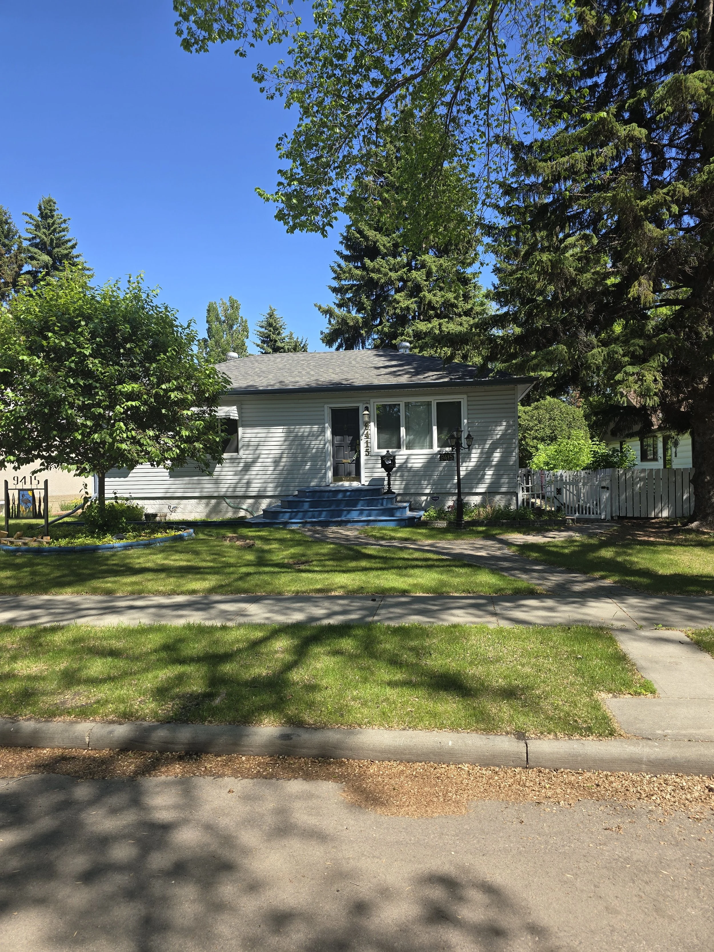 Photograph of a bungalow on a residential street.