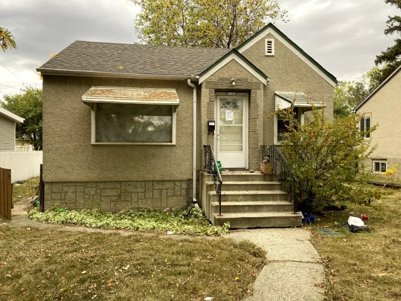 Photograph of a small, single-family house.
