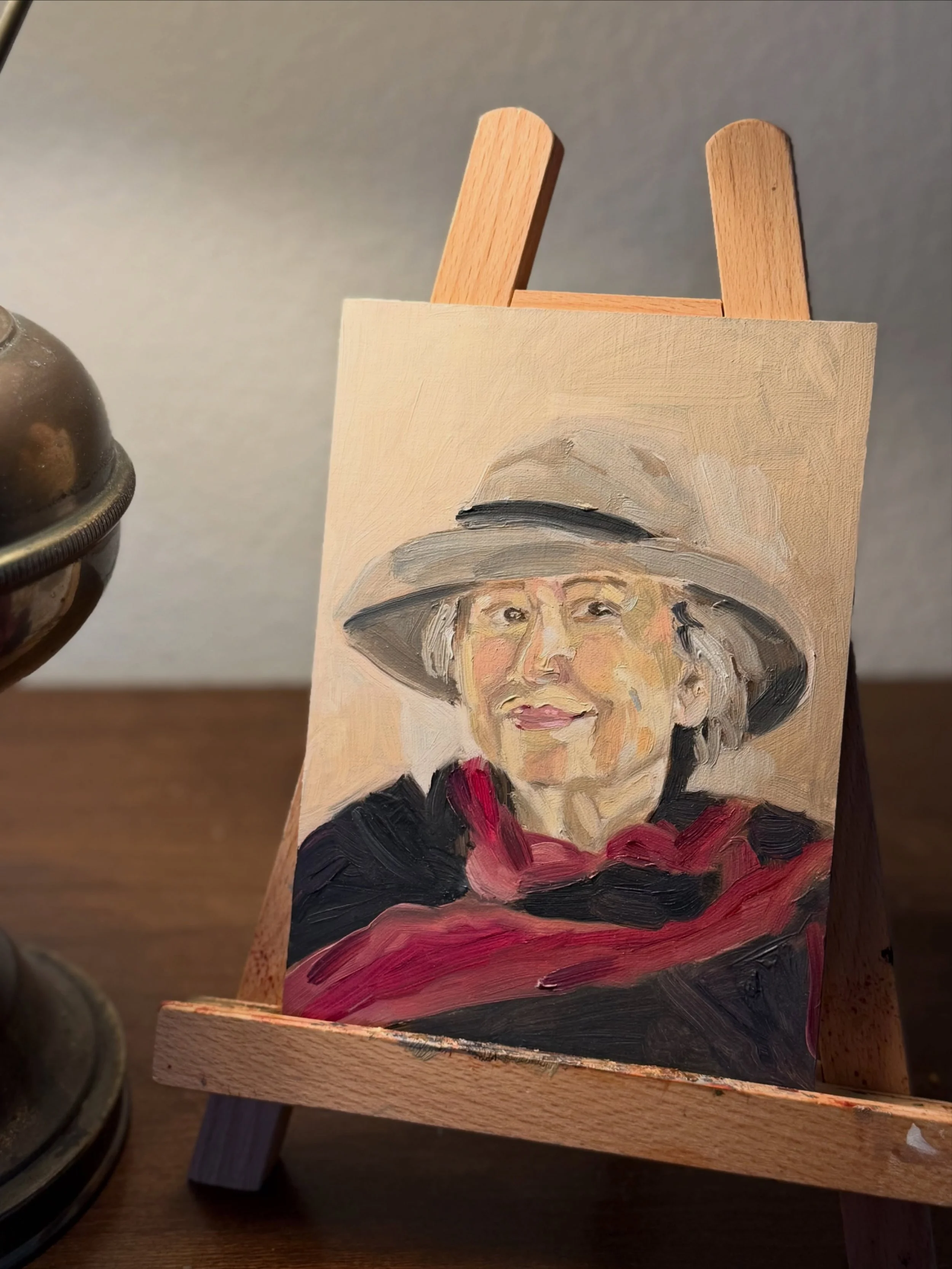 Impressionistic oil study of Mrs. Lucy wearing a wide-brimmed hat and magenta-red scarf at Midtown Coffee House.