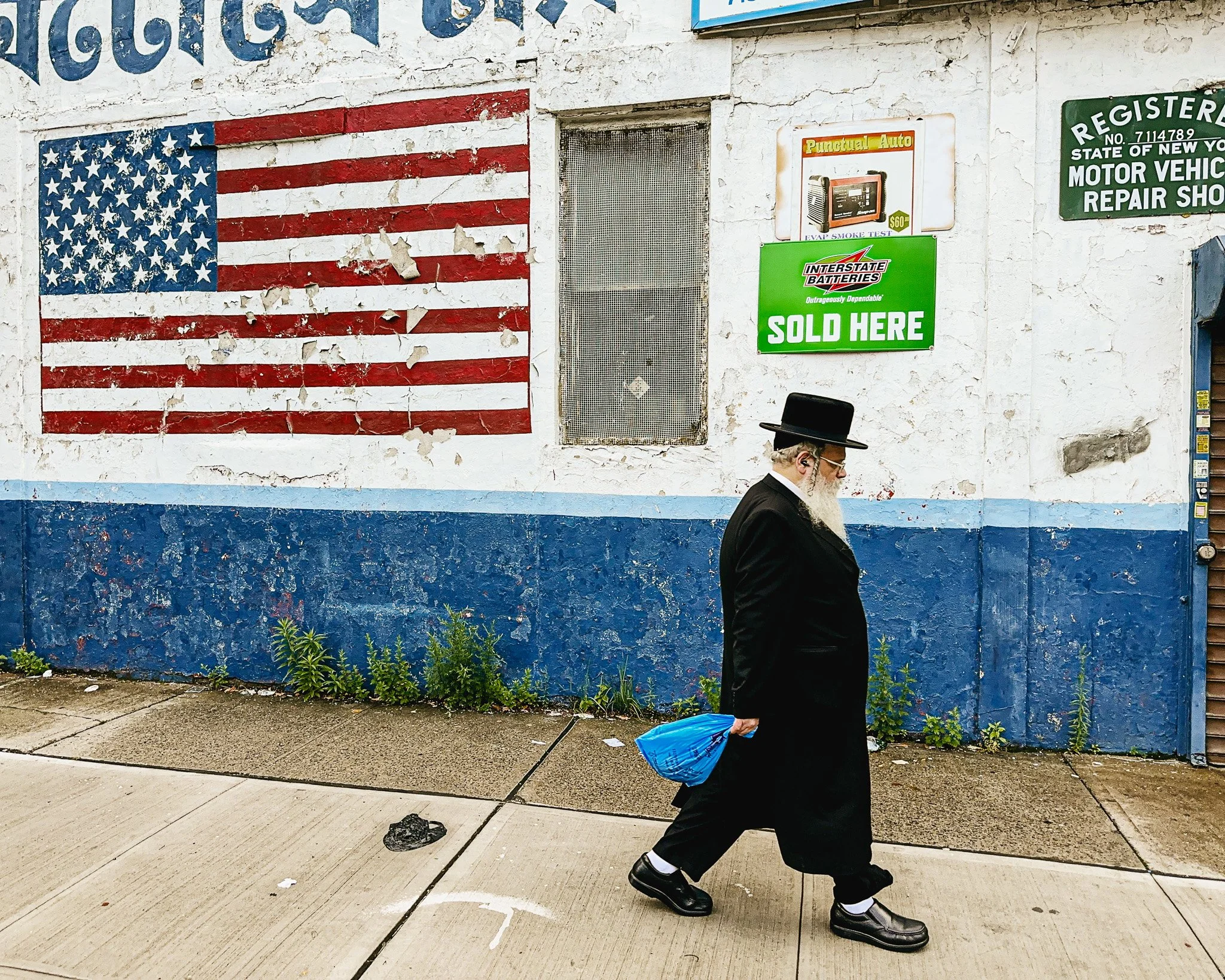 Man Walking Past American Flag, Brooklyn, NY