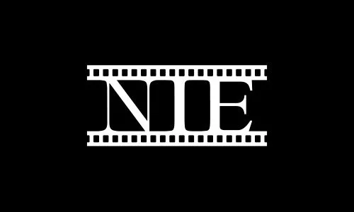 The word 'NOE' in white capital letters on a black background, flanked by film strip borders.
