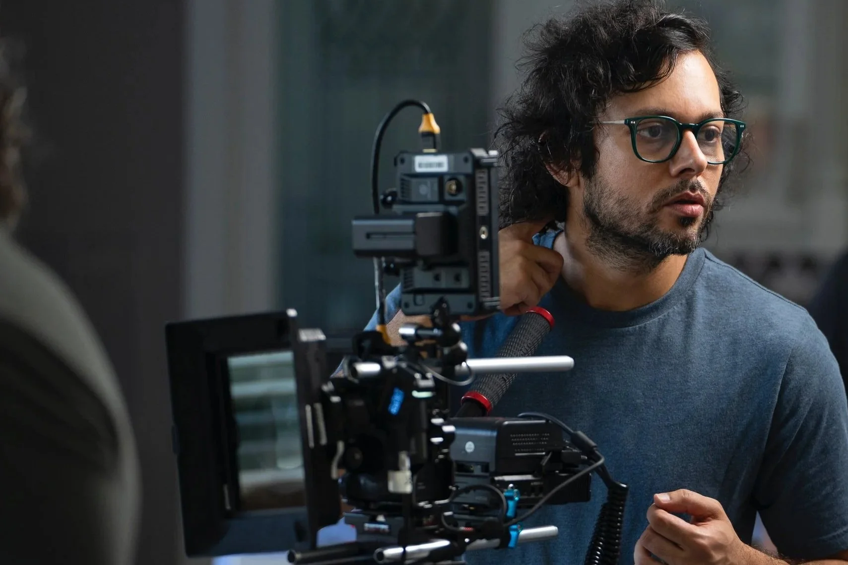 Hassam Mairaj – Vancouver-based Director of Photography with over 14 years of experience across narratives, documentaries, and TV. Operating film production equipment, including a camera mounted on a rig, on a film set.