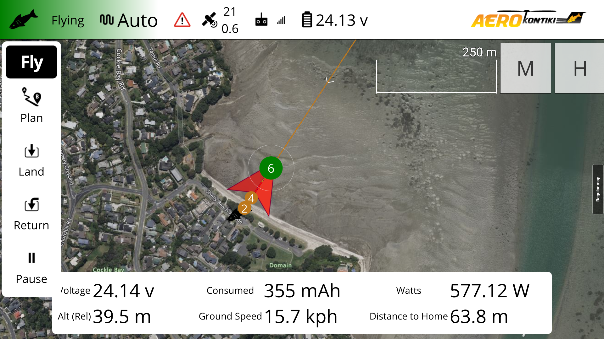Aerial drone map showing a coastal residential area with a beach, roads, and houses. Flight interface with control options, telemetry data, and a flight path marked in orange, indicating altitude, voltage, current, power, and distance metrics.