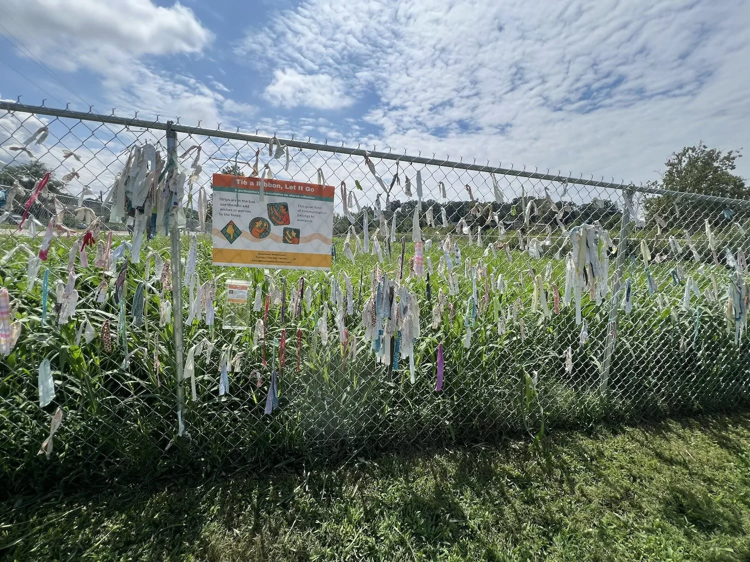 On a hot midday visit, I found the box empty. The vibrant Local Cloth strips that had been added weren’t on the fence — it seems they may have been taken again.