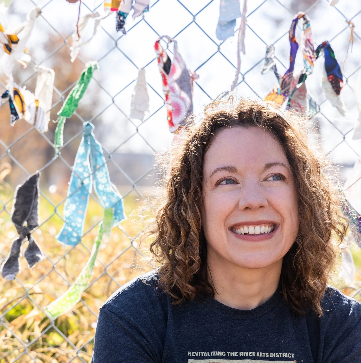 Artist standing at The Ties That Bind Asheville installation during the closing event in Asheville, North Carolina.