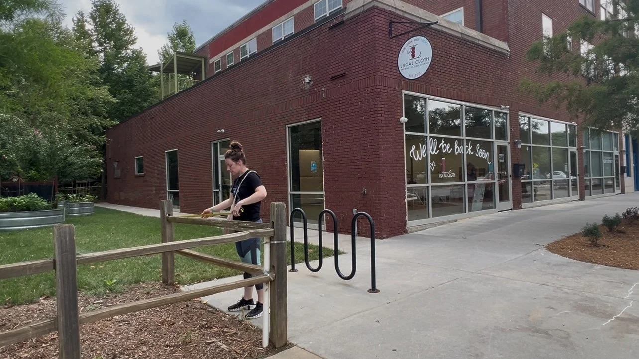 Artist preparing offsite activation of The Ties That Bind Asheville at Local Cloth in Asheville, North Carolina.