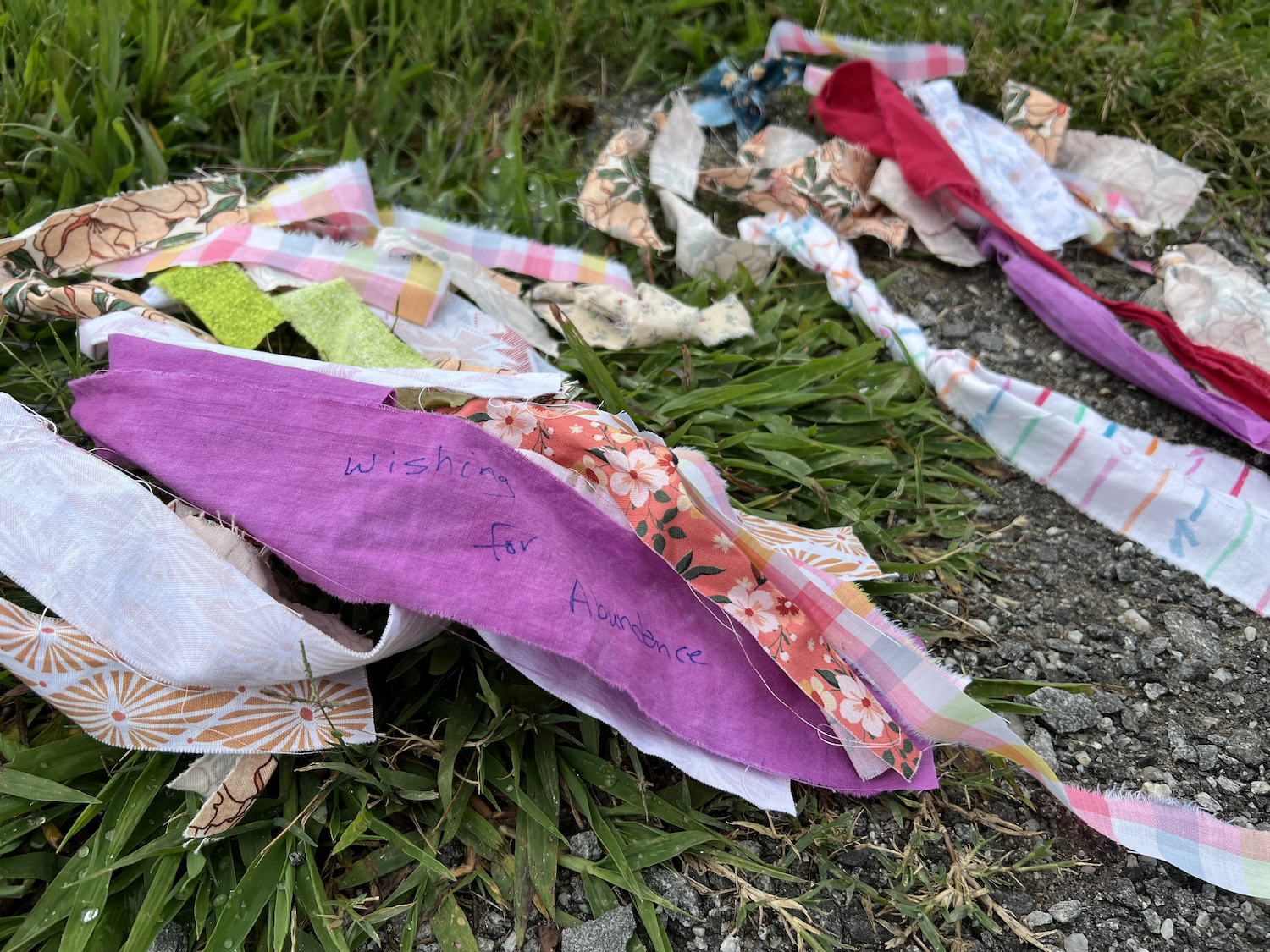 Close-up of fabric strips from Local Cloth members. Someone took the opportunity to write a wish.
