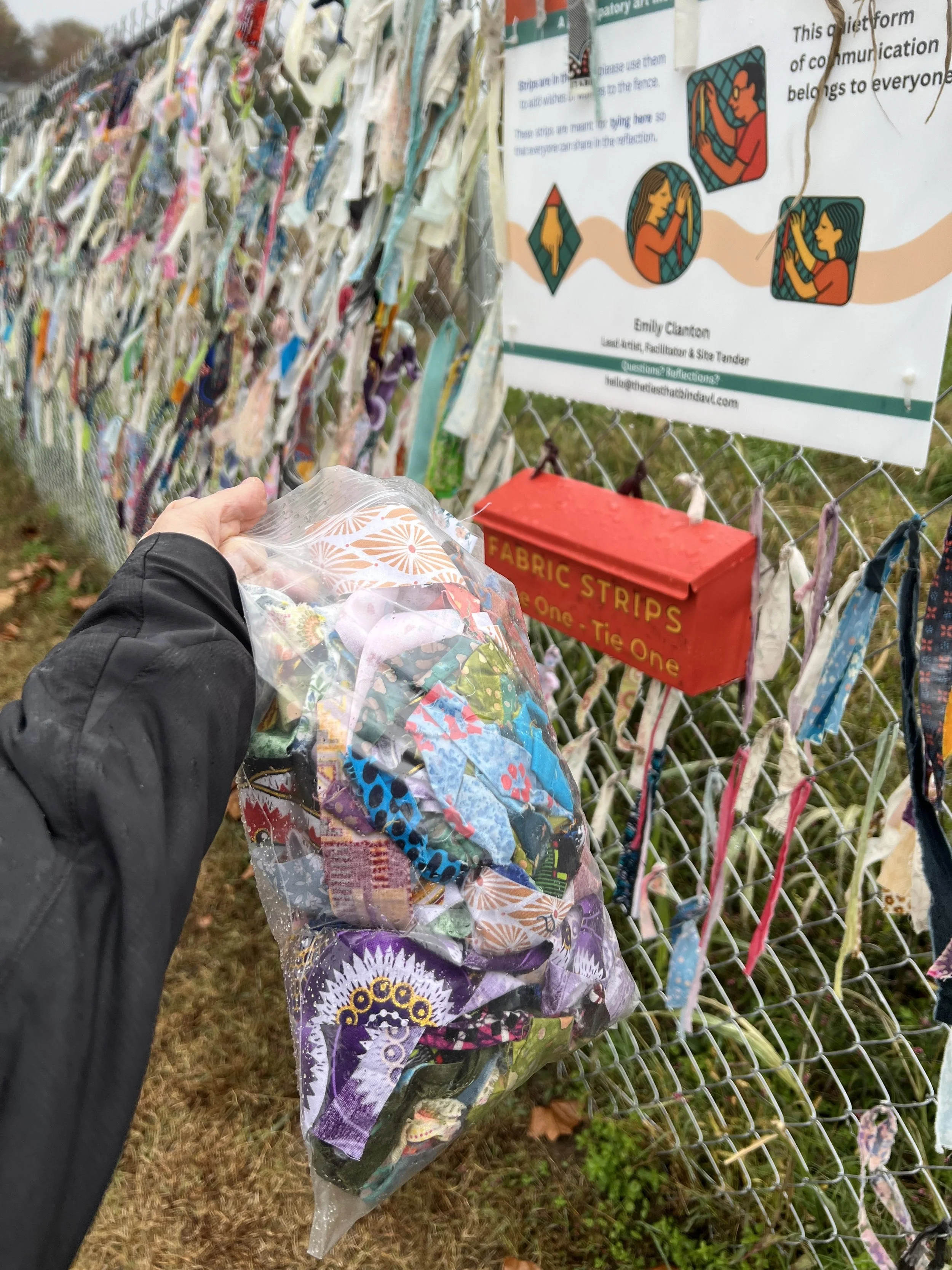 Lead artist brings materials to replenish the distribution box.