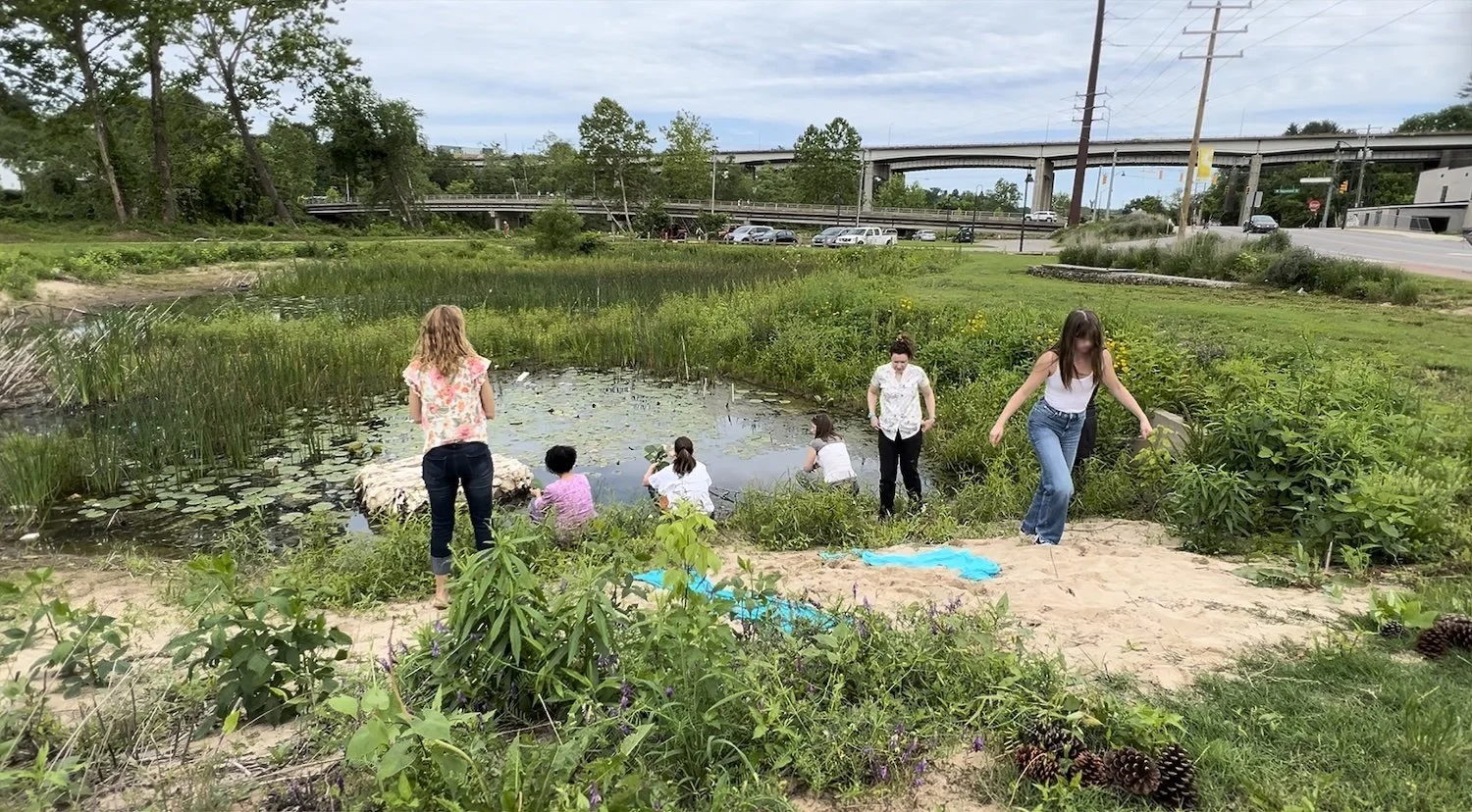 A community ceremony of symbolic release — tending grief through shared ritual and fleeting beauty.
