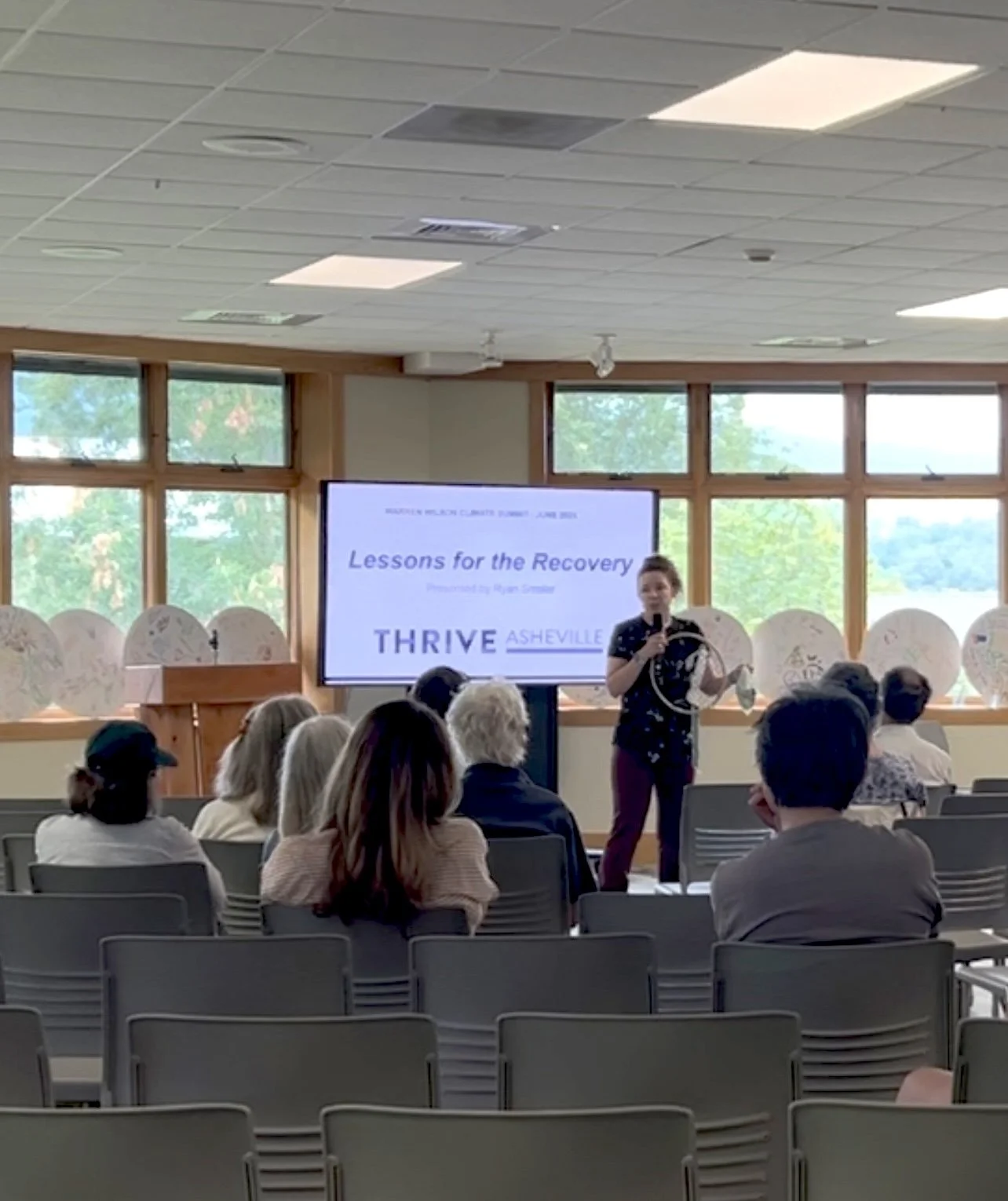 Video still of Emily Clanton presenting an offsite activation at the start of the Thrive Asheville presentation.