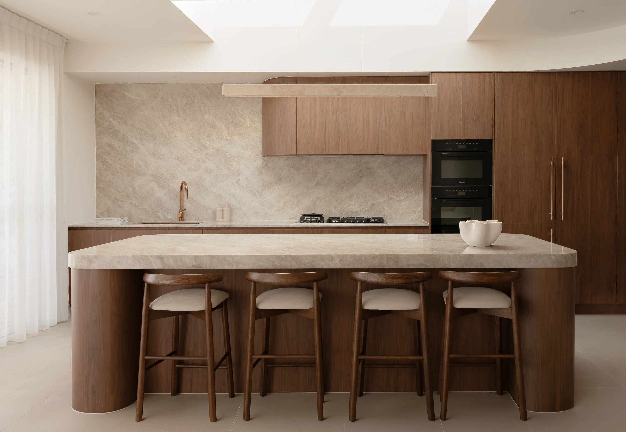 florentine walnut kitchen, natural stone and beautiful lighting. Abi fixtures