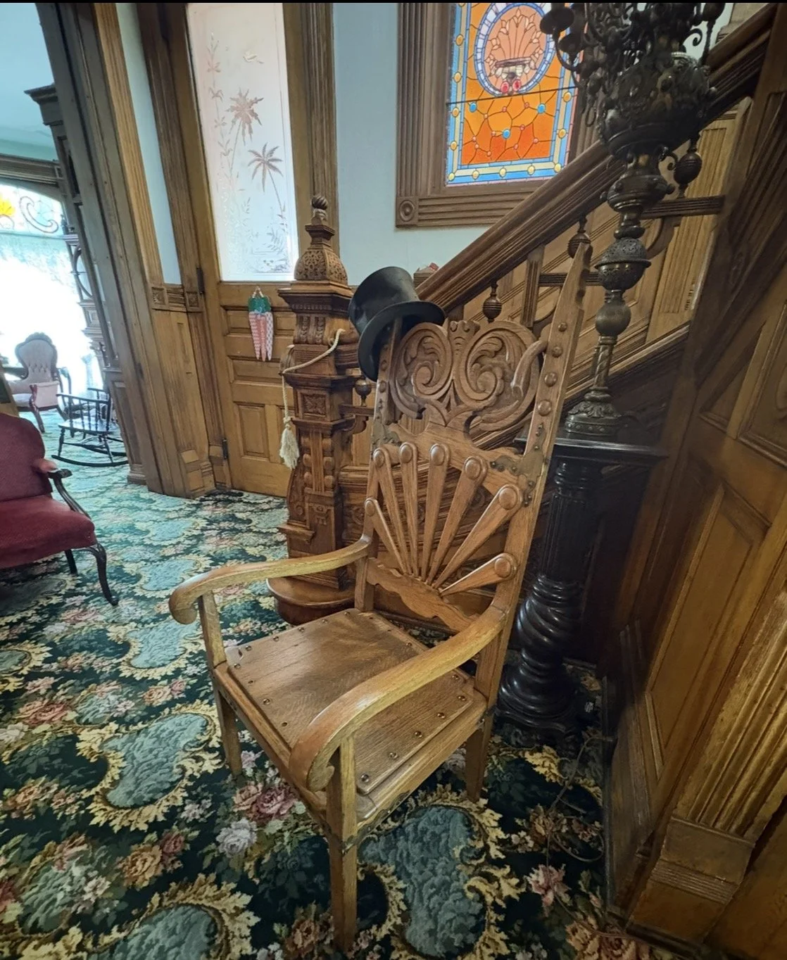 Fancy wooden chair with a top hat on it