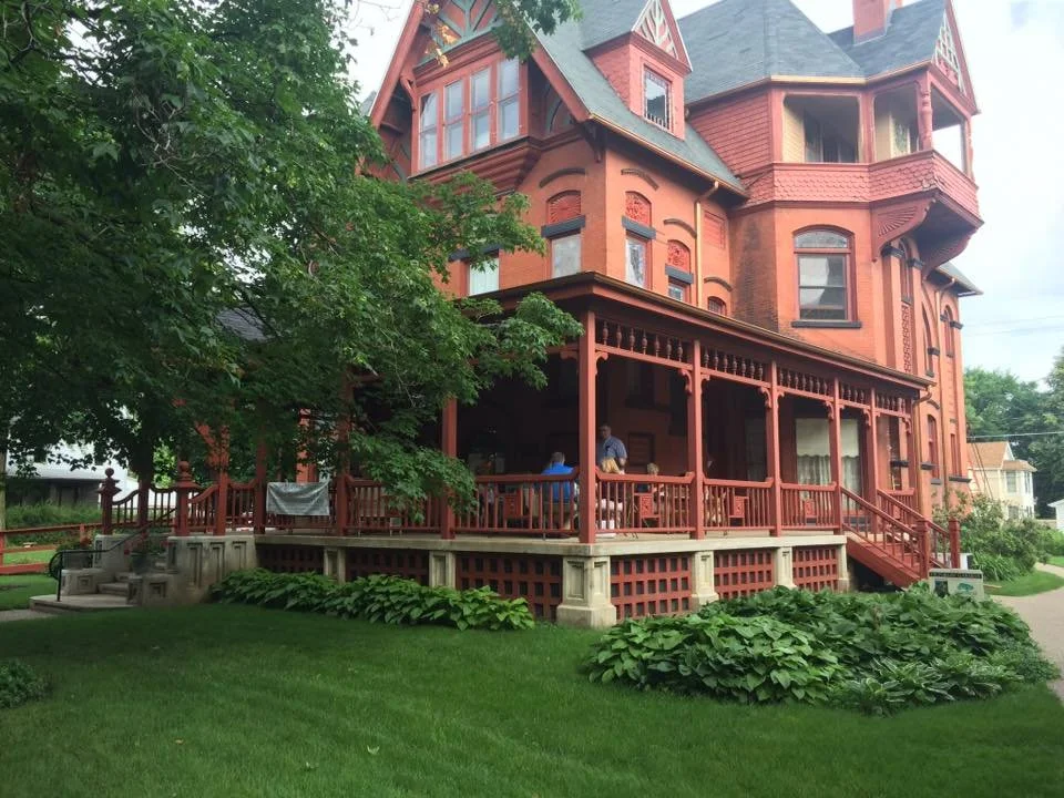Exterior of the curtis mansion while an event is going on the patio