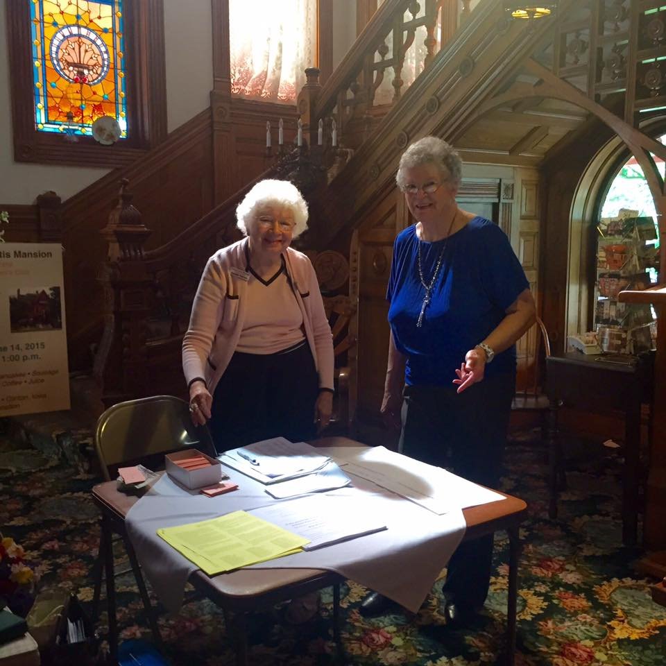 Clinton Women's Club Members in front of a sign-up table