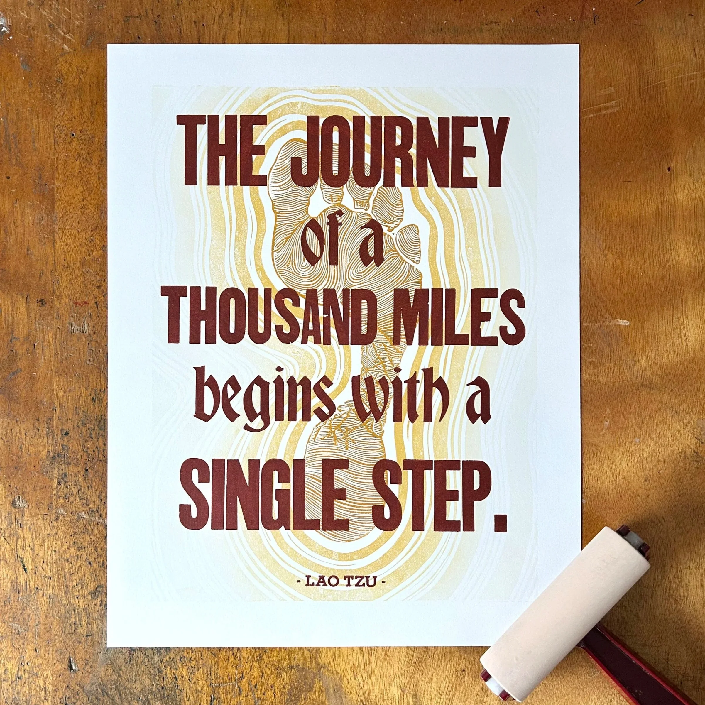 The Journey of a Thousand Miles begins with a Single Step - letterpress quote on linocut footstep background, 11" x 14" white Stonehenge paper (2025)