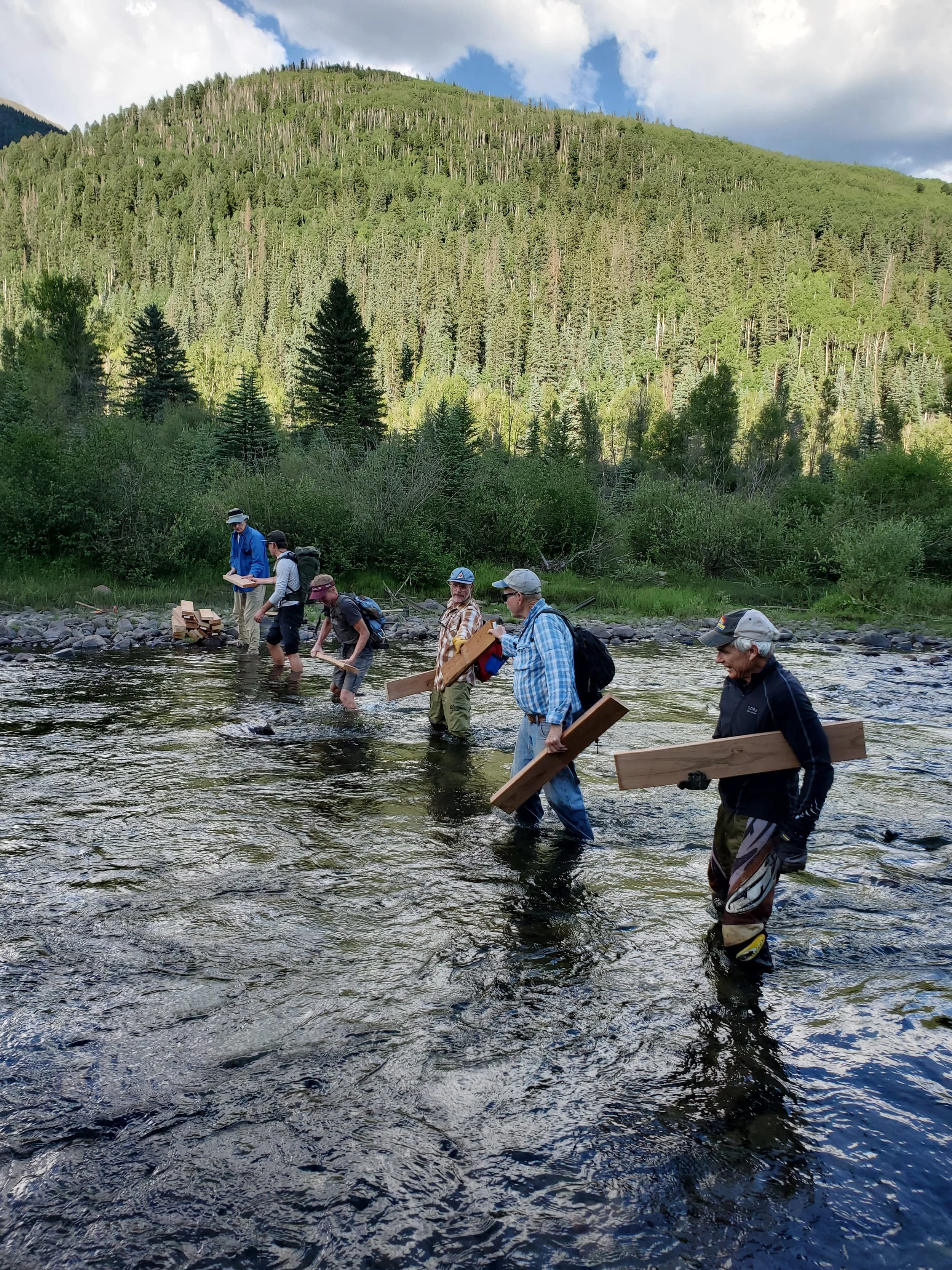 RTA volunteers shuttle items across the river near Rico, Colorado