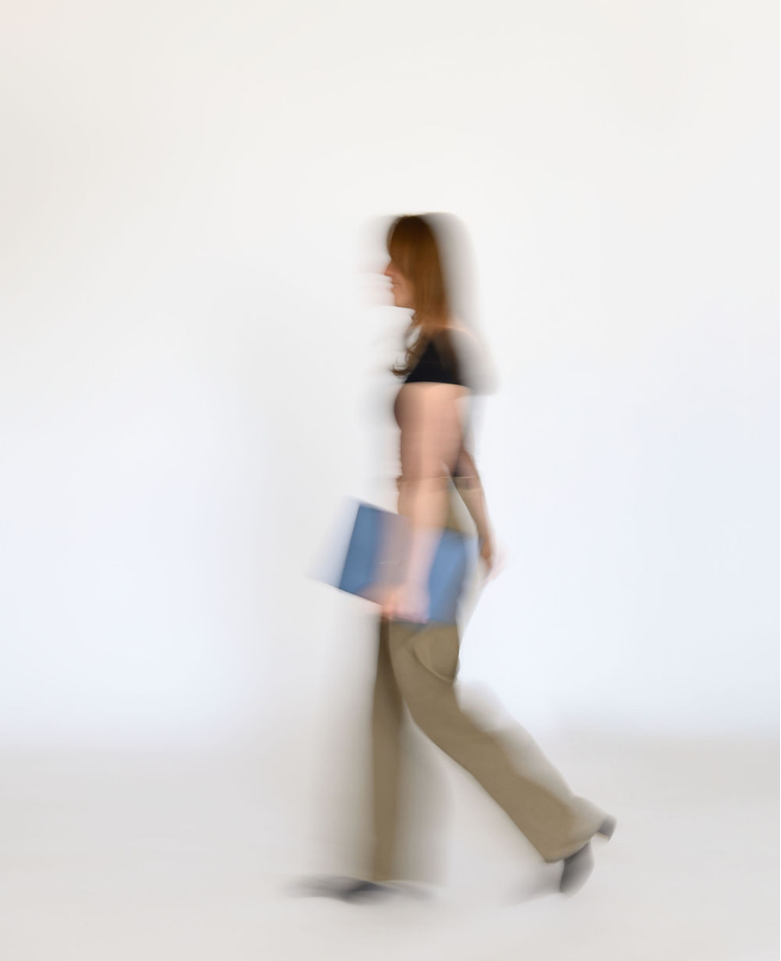 Emily Jachimiak walking with a folder, symbolizing forward movement and strategic financial support for growing businesses.
