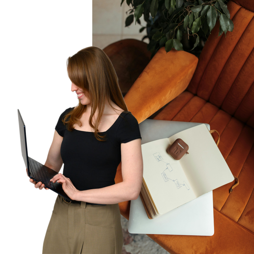 Emily Jachimiak working on a laptop in a modern workspace, representing fractional CFO services and small business financial strategy.