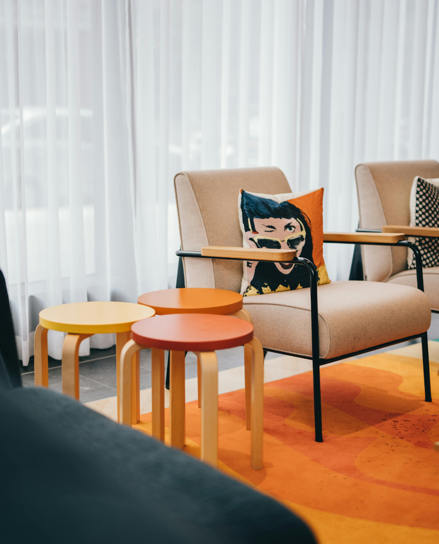 Modern seating area with colorful decor, used as a lifestyle visual for a small business finance brand.