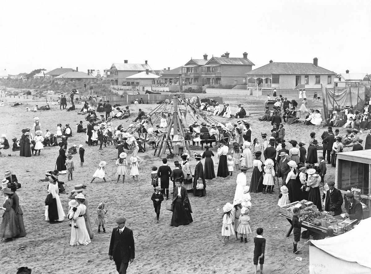 A busy beach in 1910 with the formal attire of time. 
