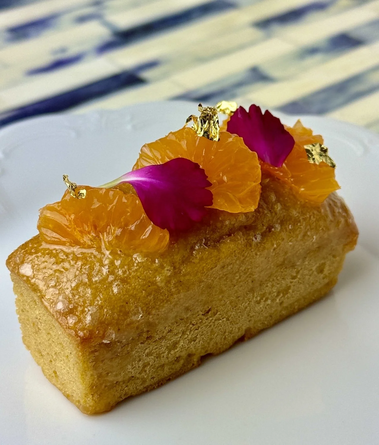 Mesquite Orange Cake with gold leaf for Afternoon Tea on white plate