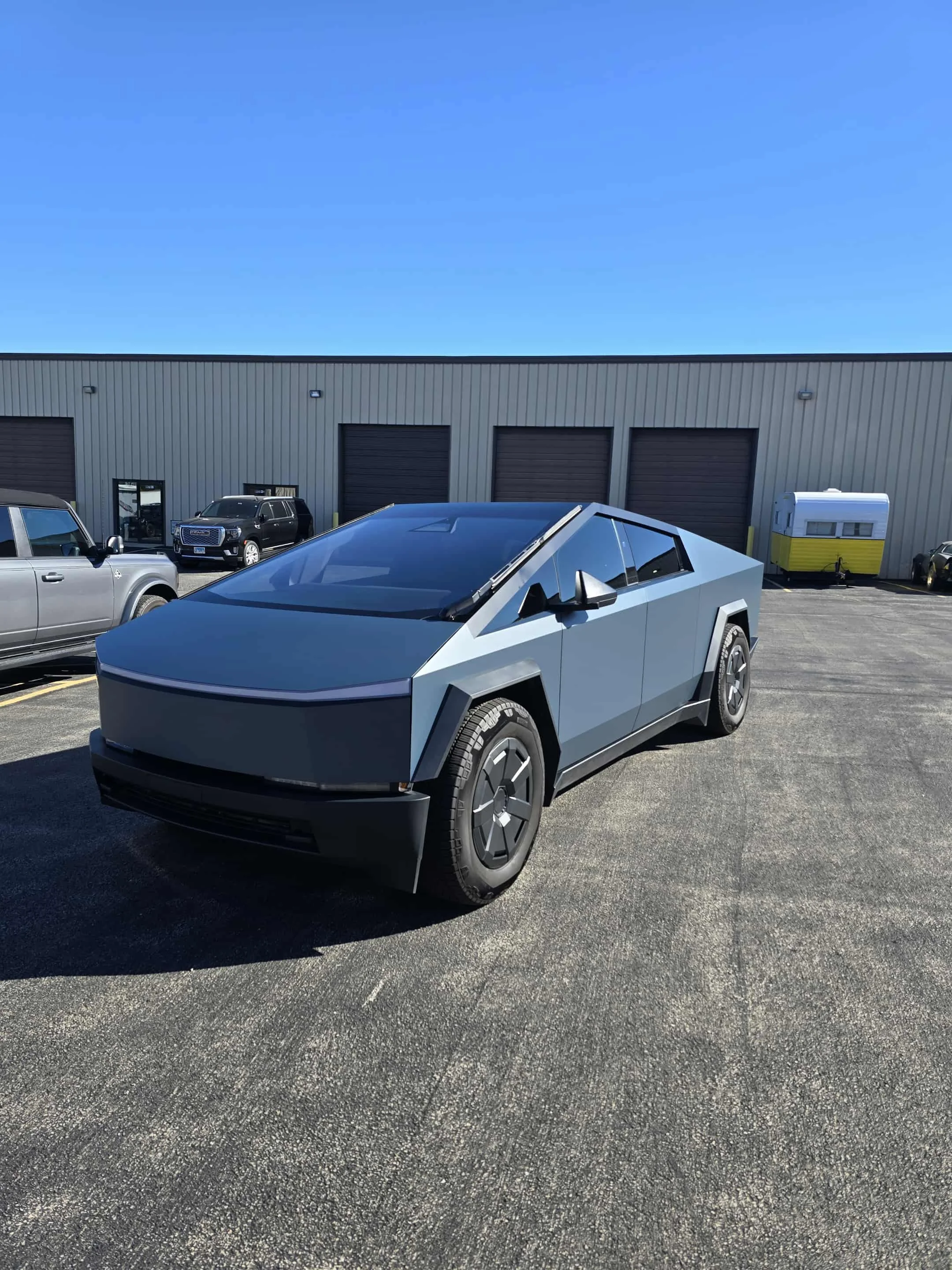 Tesla Cybertruck wrapped in Avery Dennison Satin Light Blue vinyl film, showing the unique satin finish on the stainless steel exterior.