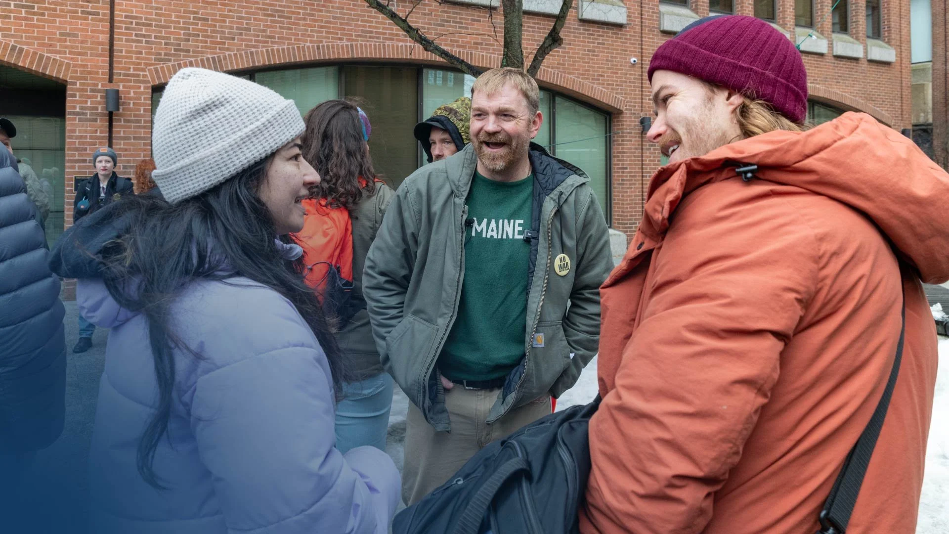 A photo of Graham Platner, candidate for U.S. Senate in Maine, talking with voters.
