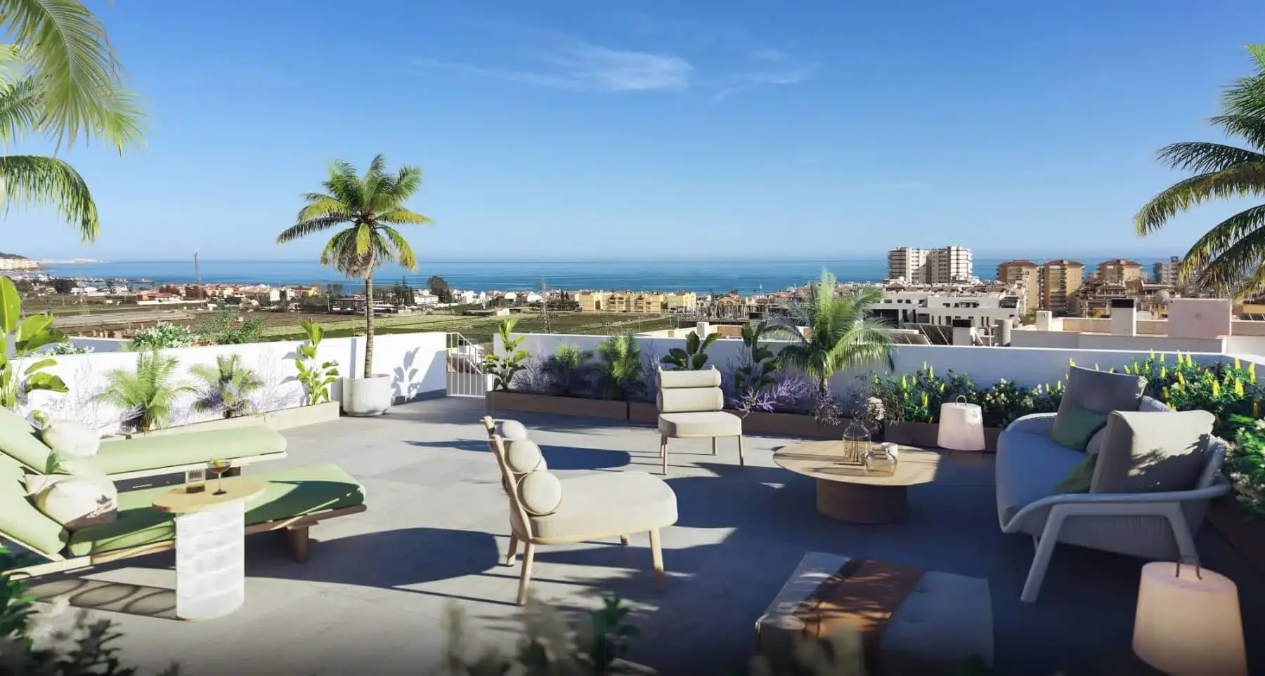 Rooftop patio with outdoor furniture, including chairs and loungers, surrounded by tropical plants and palm trees, overlooking cityscape and ocean in the distance on a clear sunny day.