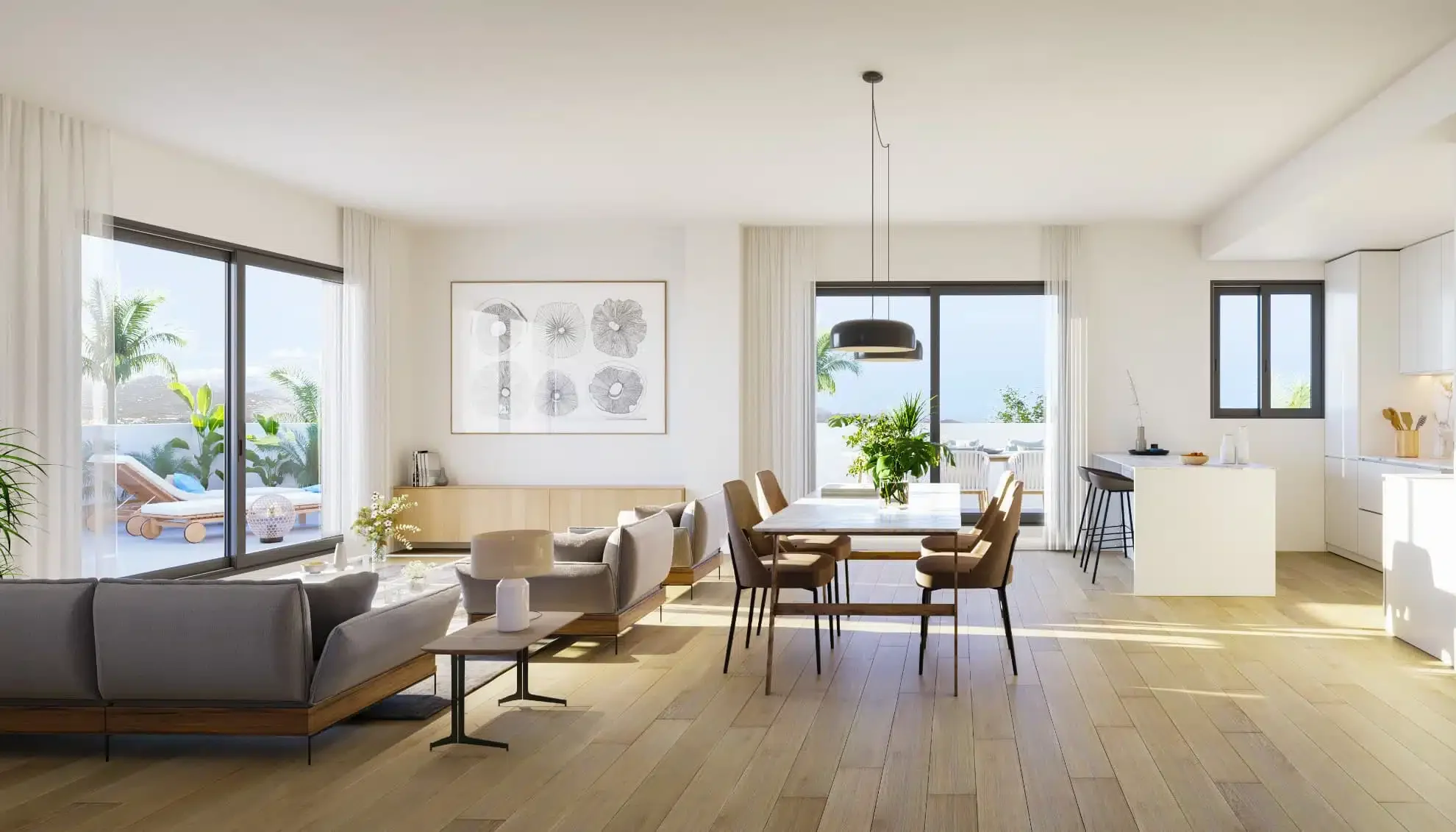 Bright, spacious living and dining area with sliding glass doors opening to a balcony with outdoor lounge chairs and tropical plants. Modern furniture, artwork, and a kitchen area with a central island.