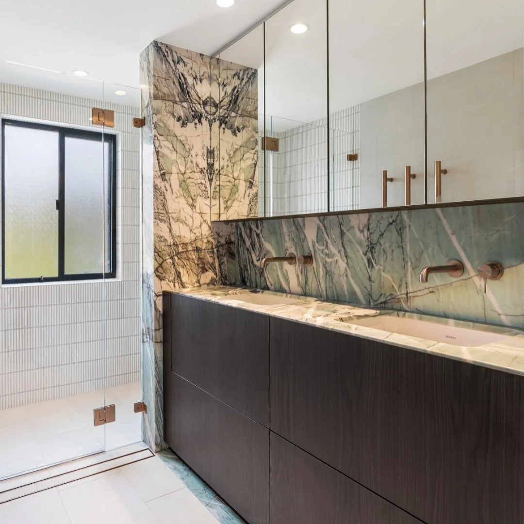 Step into clarity, refreshed. This Cronulla bathroom transforms daily routines with ultra clear glass that maintains perfect transparency and champagne hardware that adds warmth to every interaction. 

The frameless mirror door completes the experien