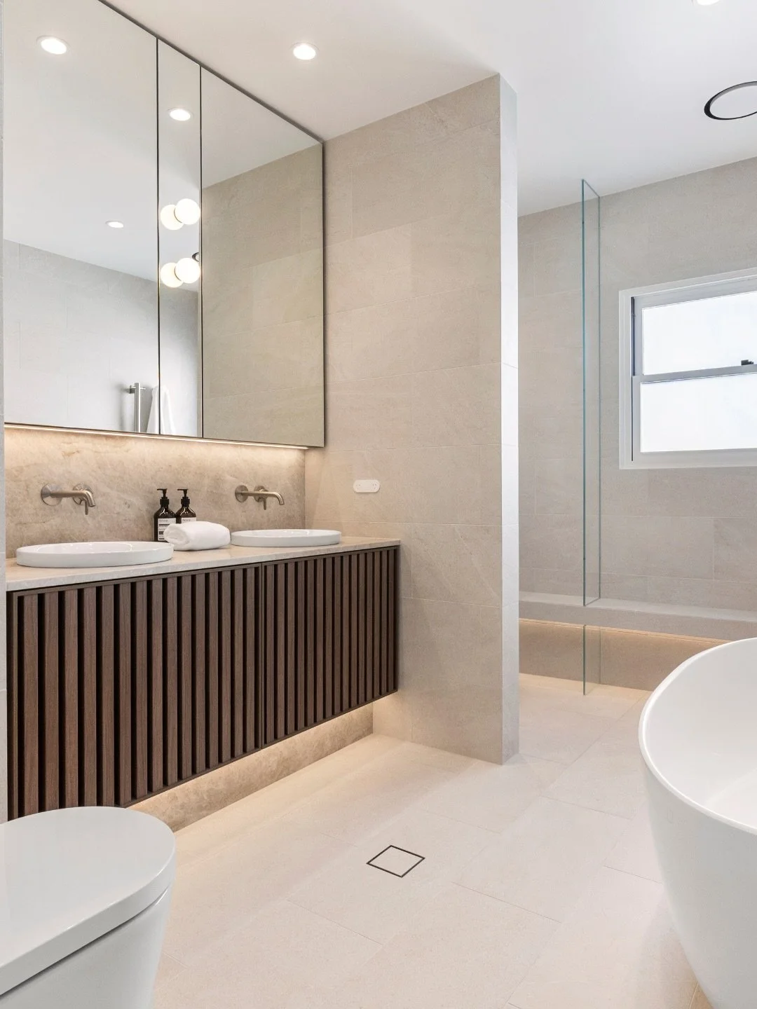 Ultra clear glass maximises light. Brushed nickel adds warmth without competing for attention.

This Concord frameless shower screen showcases how smart material choices create bathrooms that work beautifully. The ultra clear glass maintains perfect 