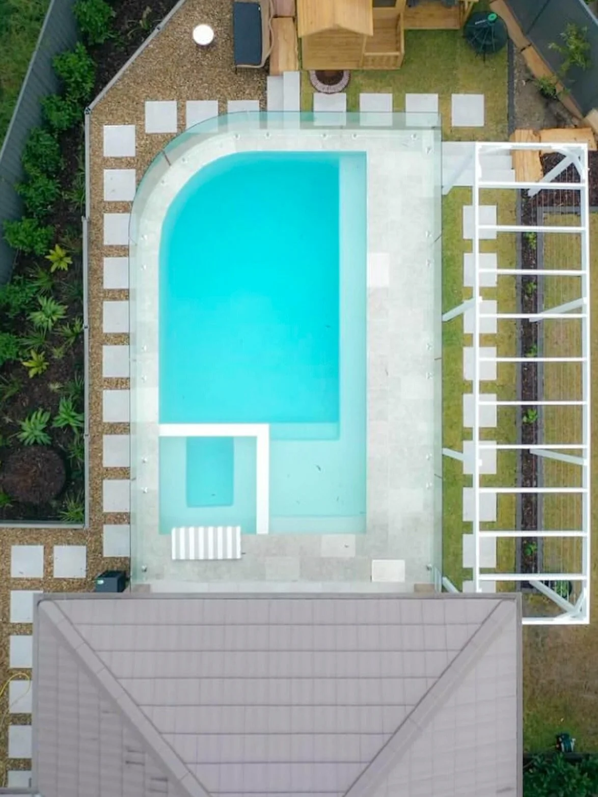 Technical expertise meets landscape design in this stunning curved glass pool fence installation.

Custom curved glass panels provide essential child safety compliance while seamlessly integrating with the landscape architecture of this North Kellyvi