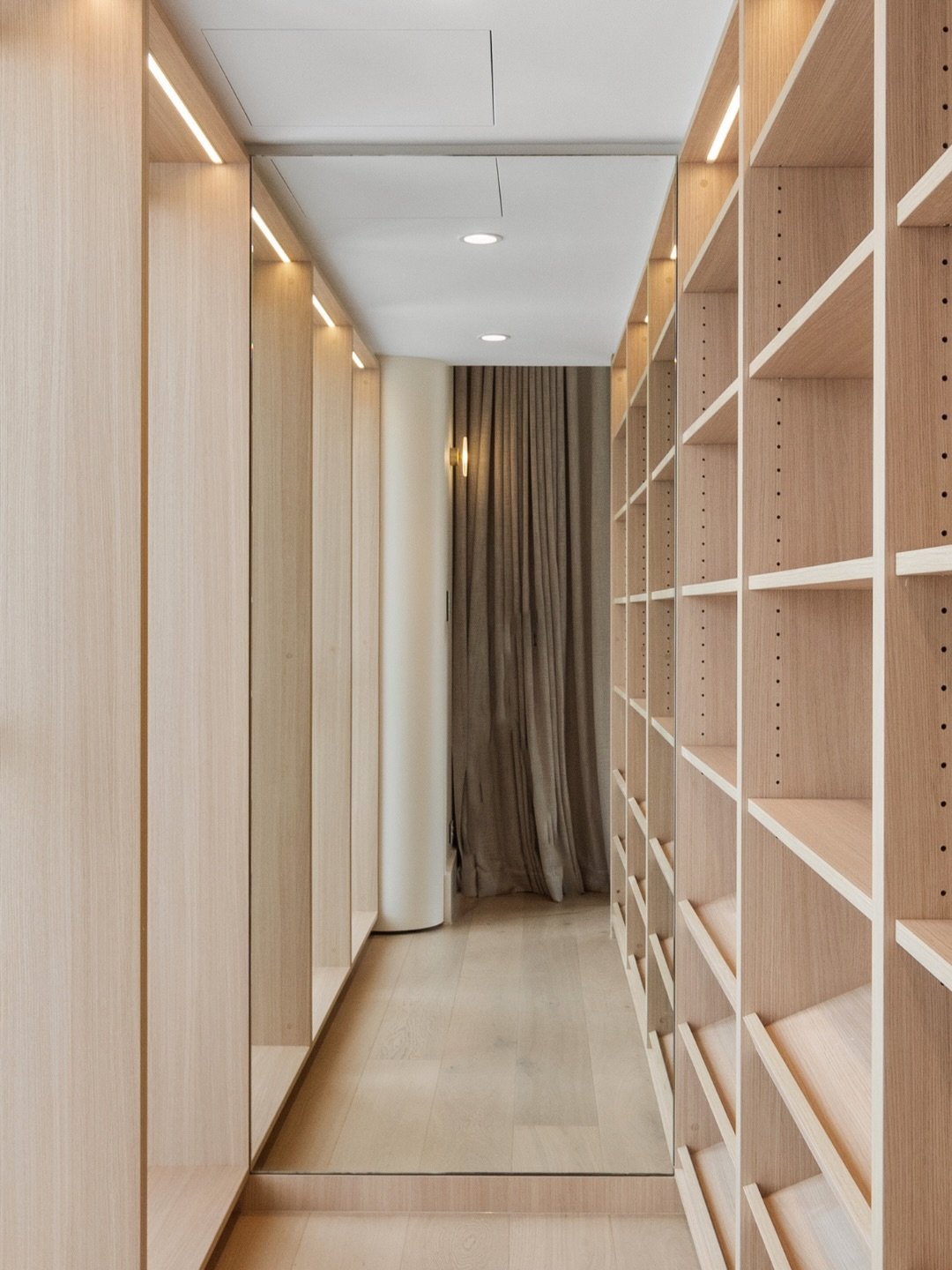 In a home this considered, nothing is accidental... including the glass.

A full-length mirror that doubles the wardrobe and draws your eye to the bedroom beyond.

A frameless shower screen that steps back so the bookmatched marble can command the ro