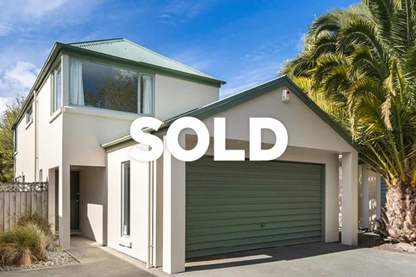 Modern two-story house with a sold sign overlay
