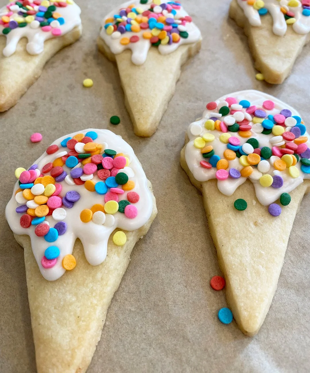 Ice cream shaped cookies with rainbow sprinkles.