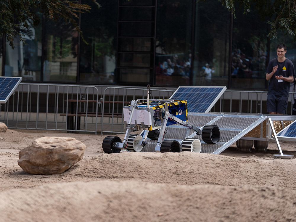A rover with 6 wheels climbing up.
