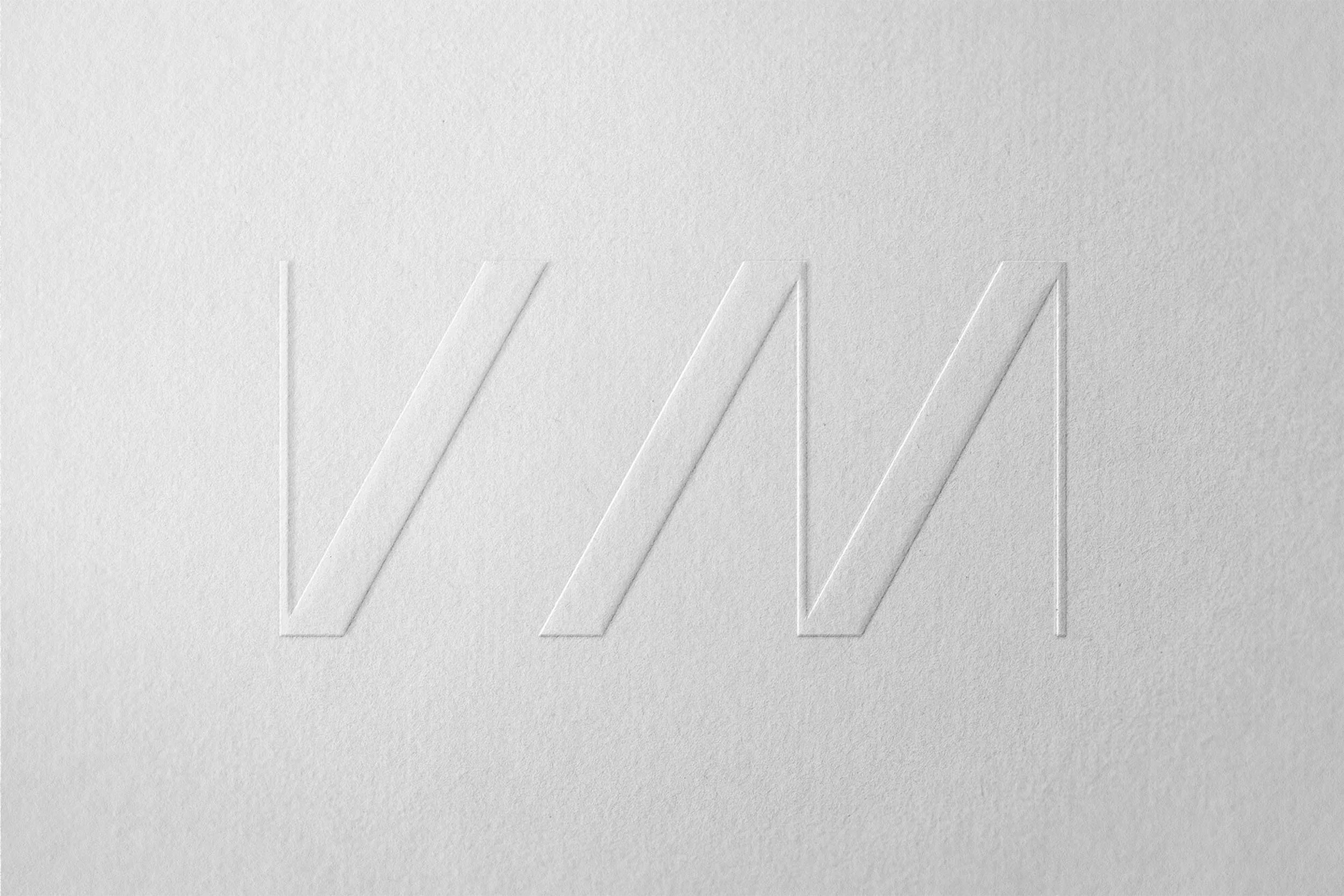 V M embossed Logo on textured paper