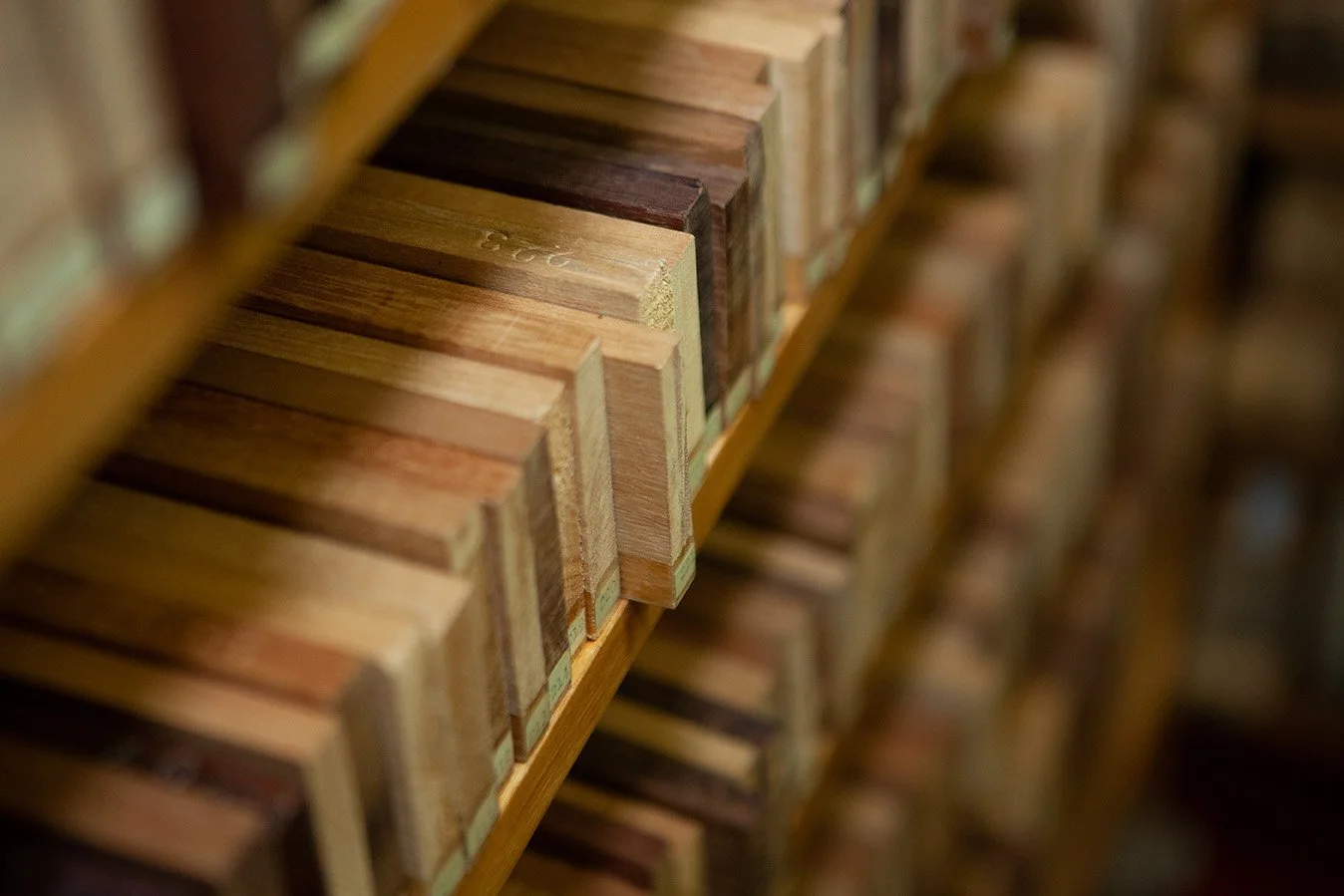 Shot of wooden sample books on a shelf, showing various wood finishes and colors.