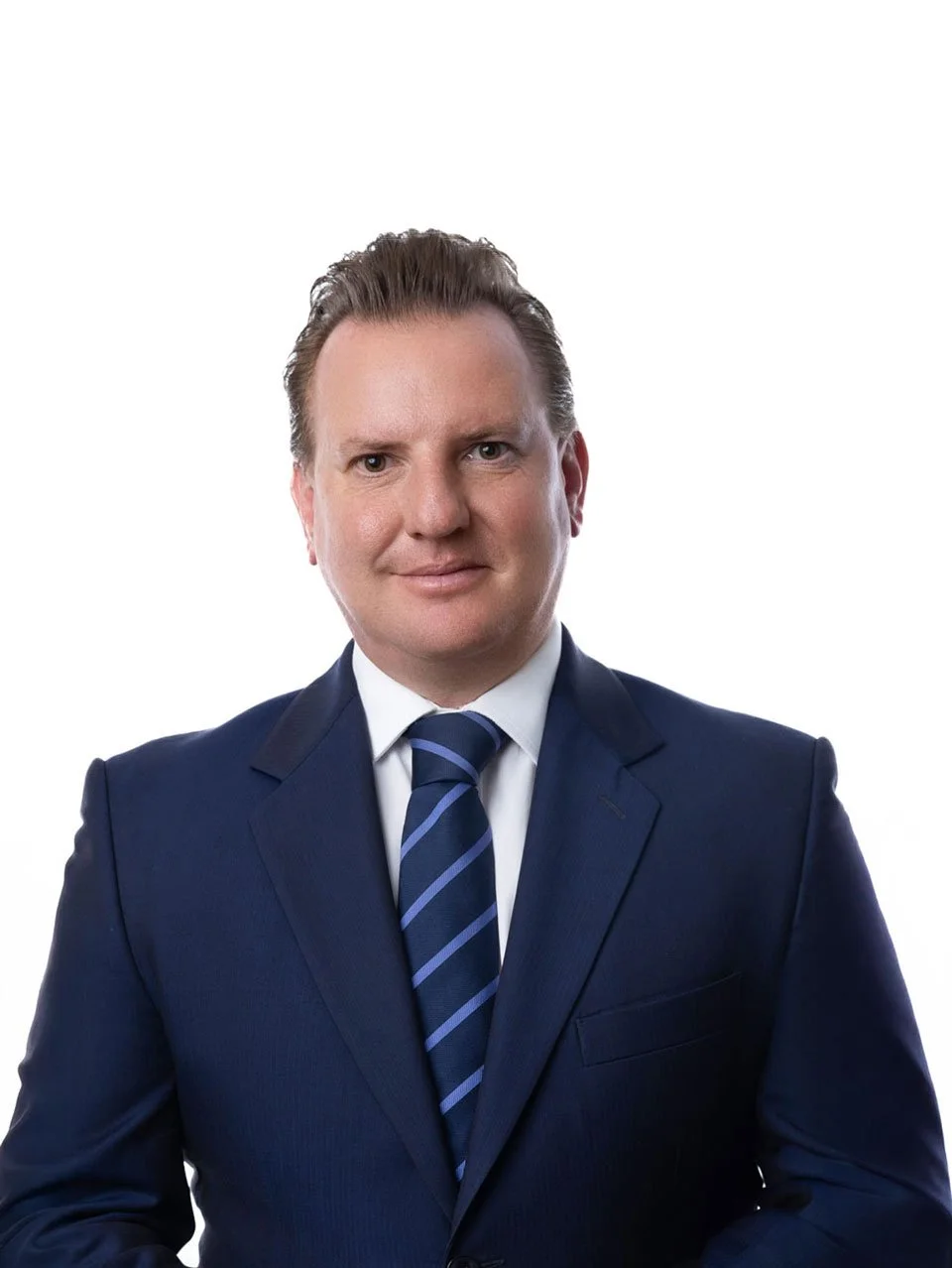 A professional man in a navy suit, white shirt, and striped tie, posing against a plain white background.