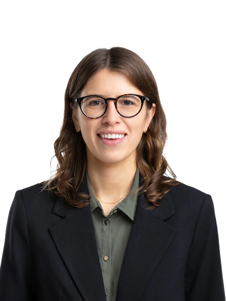 Elizabeth Jackson, a woman with brown hair, glasses, and earrings, dressed in a business suit and shirt, smiling against a white background.