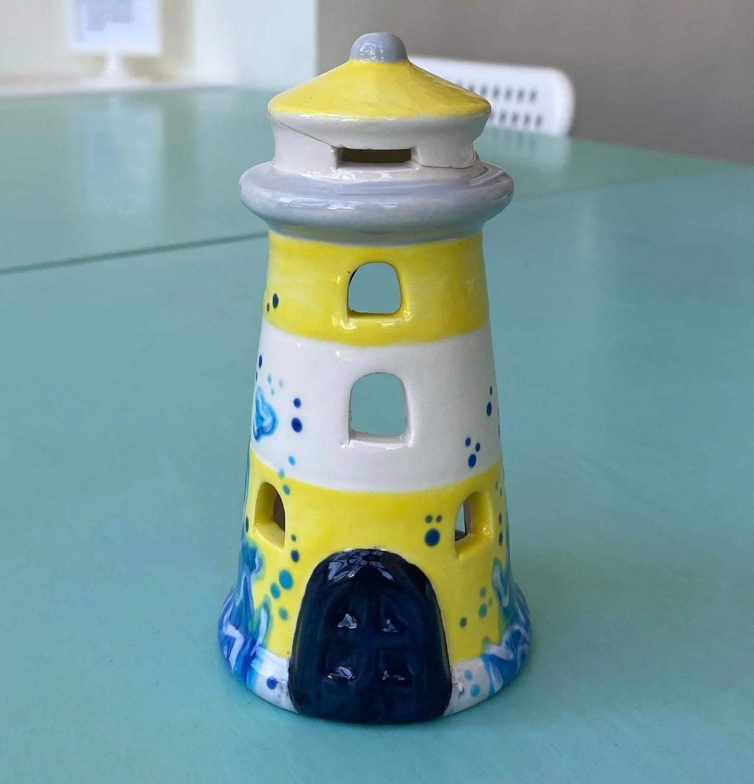 Lighthouse with waves. Fixed in the kiln