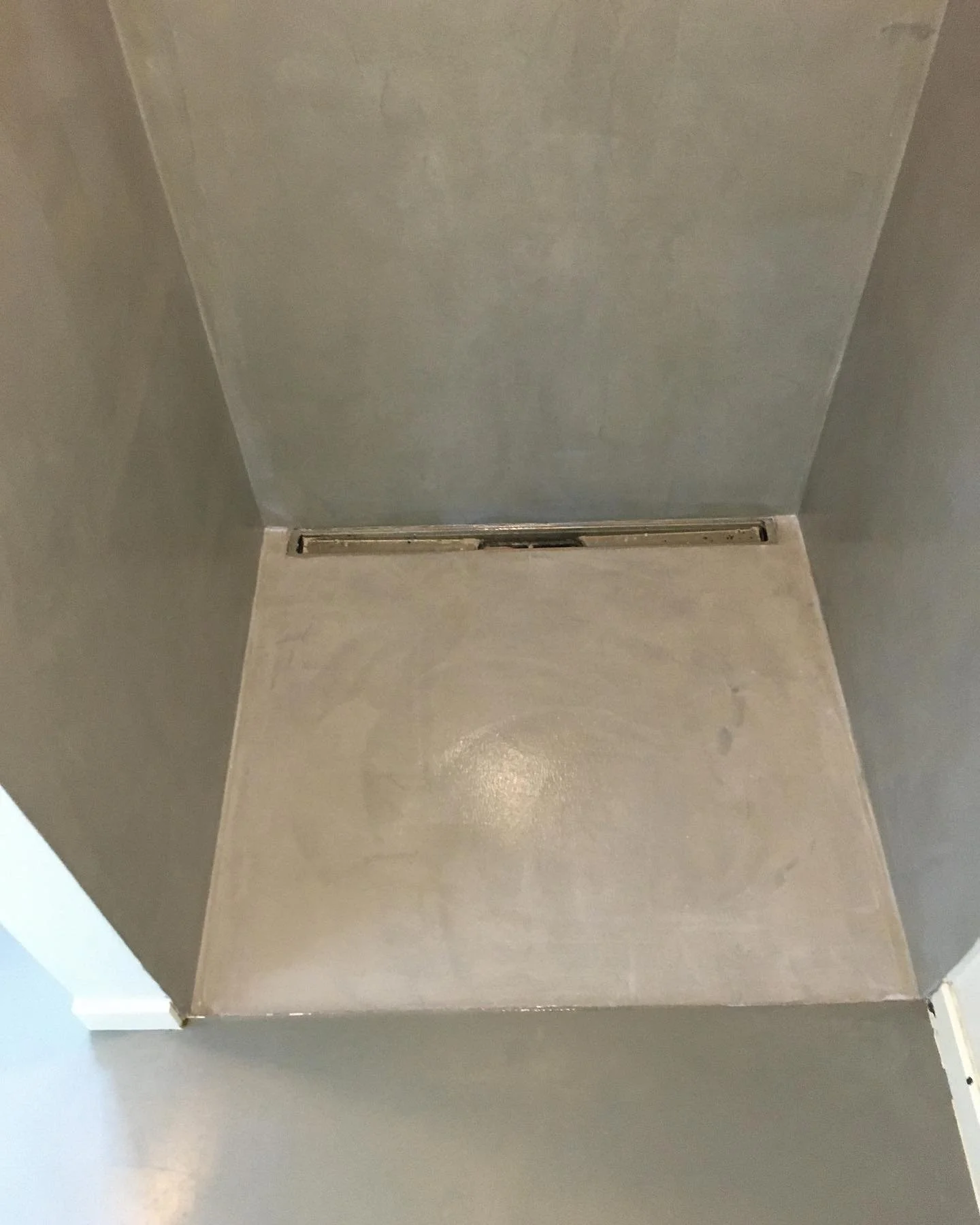 Microcement udf&oslash;rt i brusekabinen og PU-gulv p&aring; resten af badev&aelig;relset. En rigtig flot kombination.