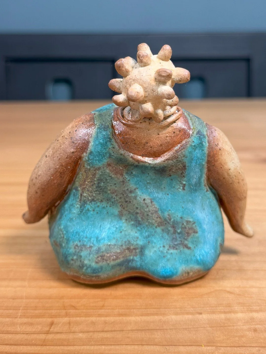 Back view of Sitting lady in a dress by Artist Nupur Narain DeTar, a beautiful handmade ceramic sculpture of the female form.